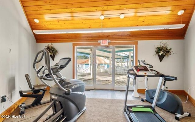 exercise area featuring light tile patterned floors, vaulted ceiling, and wood ceiling