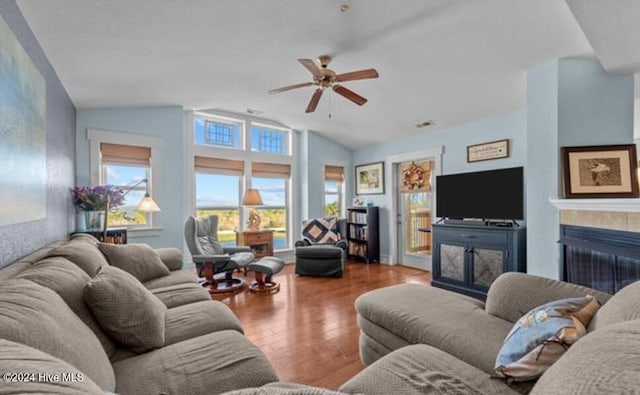 living room with hardwood / wood-style flooring, ceiling fan, and lofted ceiling