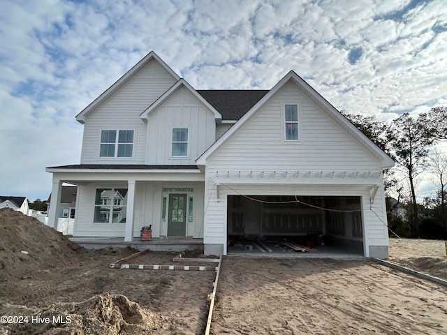 view of front facade with a porch and a garage