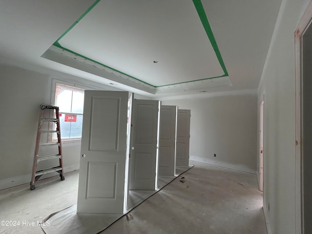 unfurnished bedroom with a tray ceiling