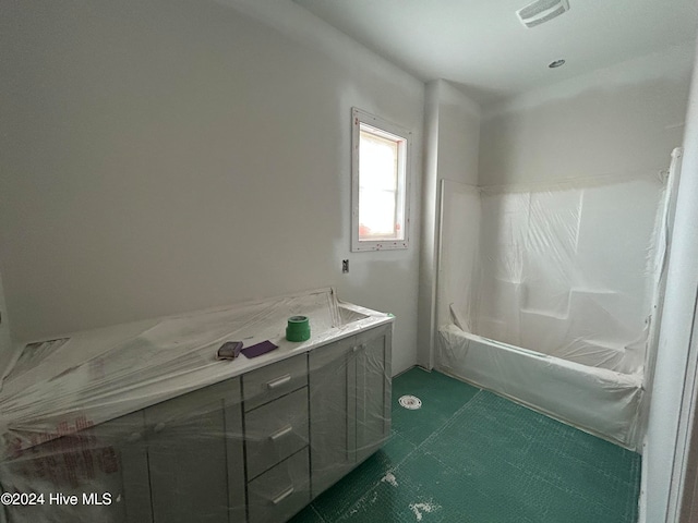 bathroom featuring tile patterned floors, vanity, and shower / bath combination