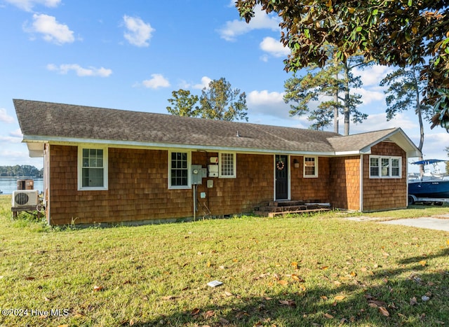 single story home featuring ac unit and a front yard