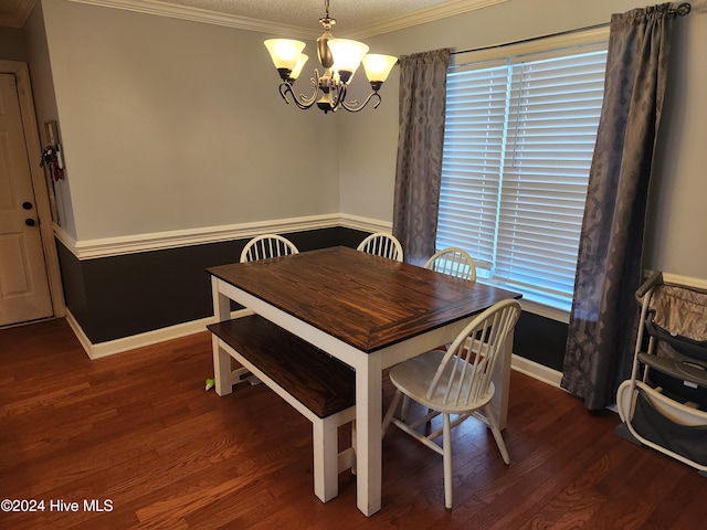 dining space with a chandelier, a textured ceiling, dark wood-type flooring, and crown molding