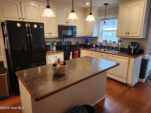 kitchen featuring a center island, sink, dark wood-type flooring, hanging light fixtures, and black appliances