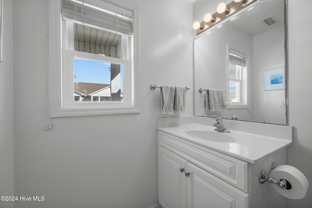 bathroom featuring a wealth of natural light and vanity