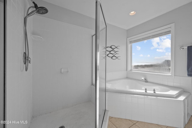 bathroom featuring tile patterned flooring and separate shower and tub