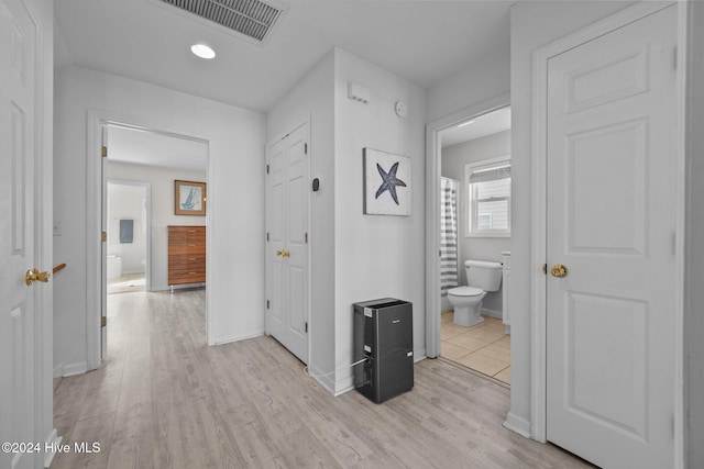 hallway with light hardwood / wood-style flooring