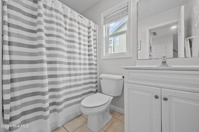 bathroom with tile patterned floors, vanity, and toilet