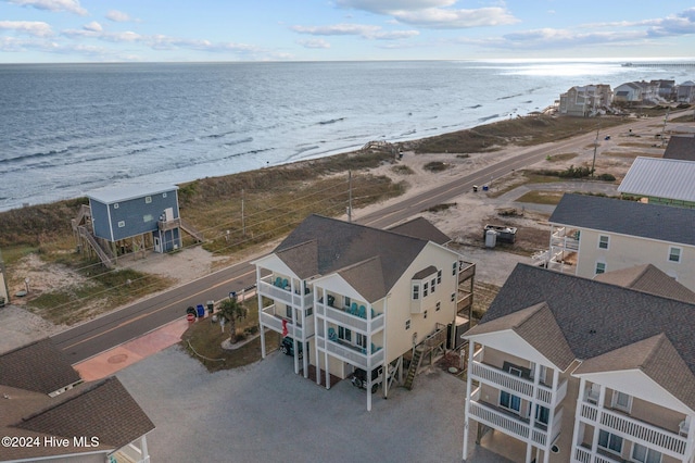 aerial view with a water view and a beach view