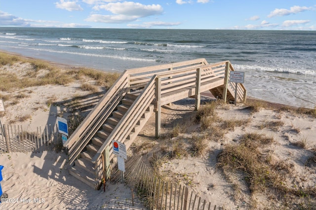 surrounding community featuring a water view and a view of the beach