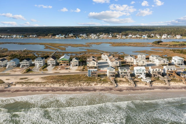 bird's eye view featuring a water view and a view of the beach