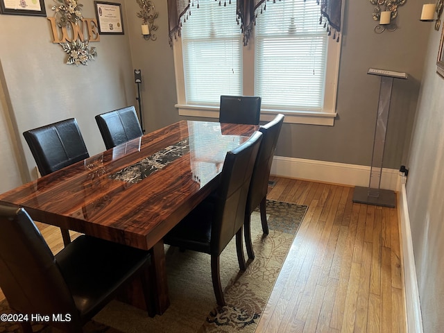 dining area featuring plenty of natural light and hardwood / wood-style flooring