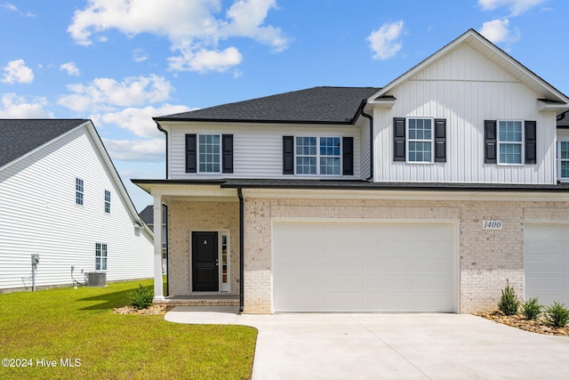 view of front of house featuring brick siding, concrete driveway, an attached garage, a front yard, and central AC