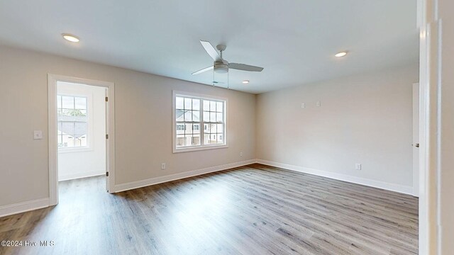 unfurnished room with a ceiling fan, baseboards, wood finished floors, and recessed lighting