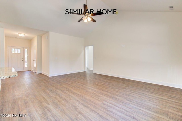 unfurnished living room with ceiling fan, vaulted ceiling, and hardwood / wood-style flooring