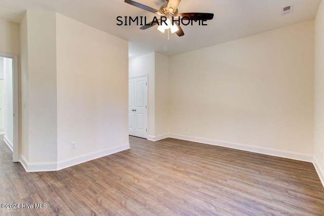 empty room with hardwood / wood-style flooring and ceiling fan