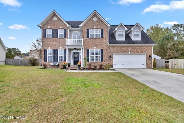 view of front of house with a garage, a balcony, and a front lawn