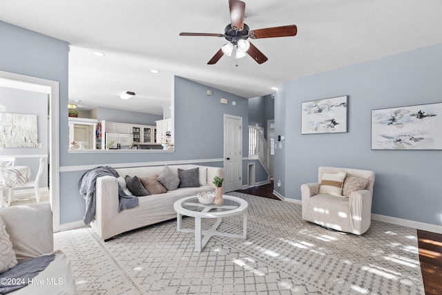 living room with ceiling fan and light hardwood / wood-style flooring