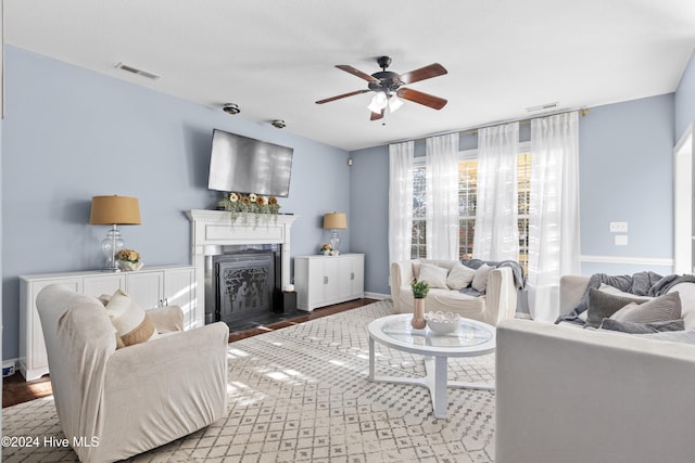 living room with wood-type flooring and ceiling fan