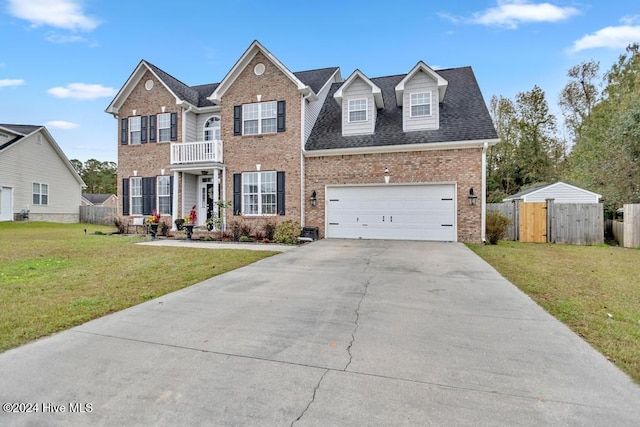 view of front of home with a balcony, a front lawn, and a garage