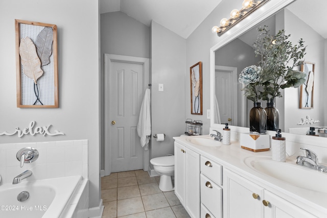 bathroom with tile patterned flooring, vanity, lofted ceiling, and tiled bath