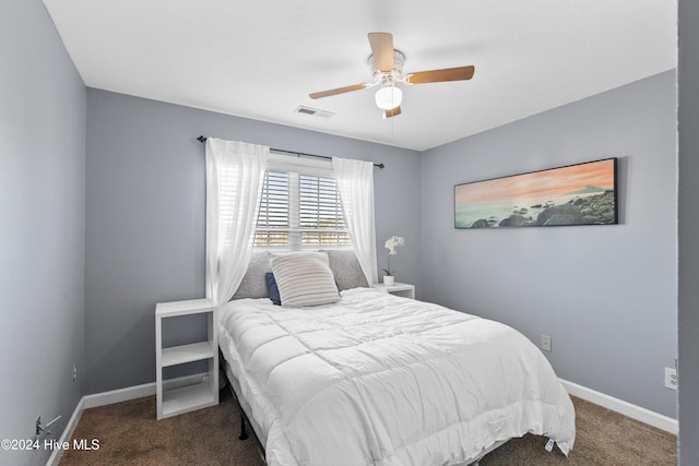 bedroom featuring dark colored carpet and ceiling fan