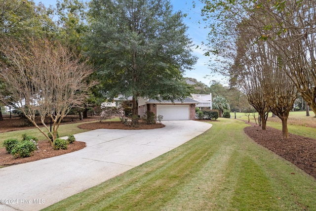 view of front of property with a front lawn and a garage