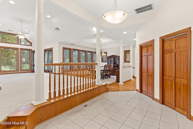 hallway featuring decorative columns and a healthy amount of sunlight