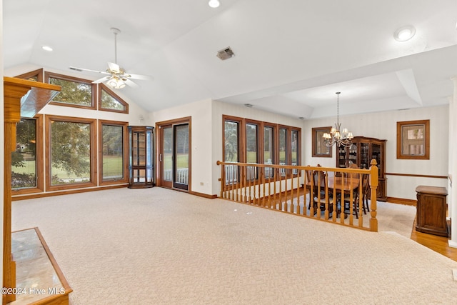 interior space featuring ceiling fan with notable chandelier and vaulted ceiling