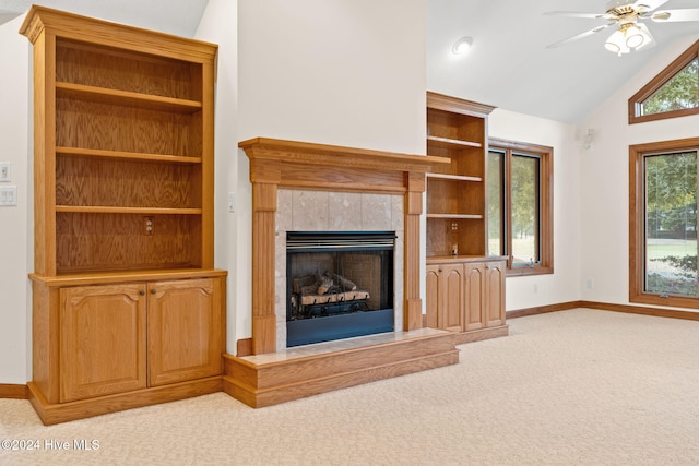 unfurnished living room featuring light carpet, a wealth of natural light, and ceiling fan