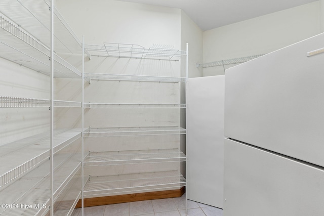 walk in closet with light tile patterned flooring