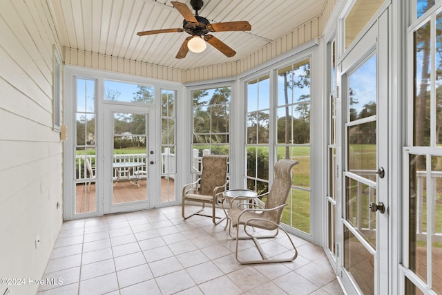 sunroom with ceiling fan, wooden ceiling, and a wealth of natural light