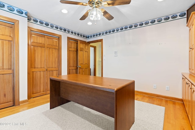 home office featuring light hardwood / wood-style floors and ceiling fan