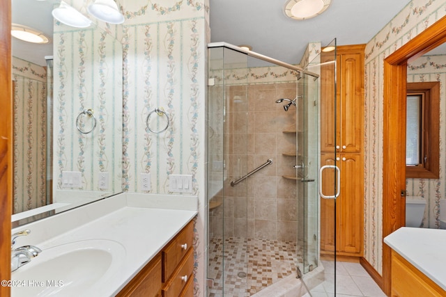 bathroom with vanity, tile patterned floors, and a shower with shower door