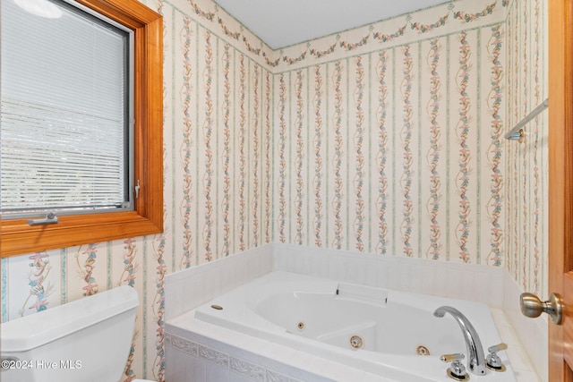 bathroom with a relaxing tiled tub and toilet