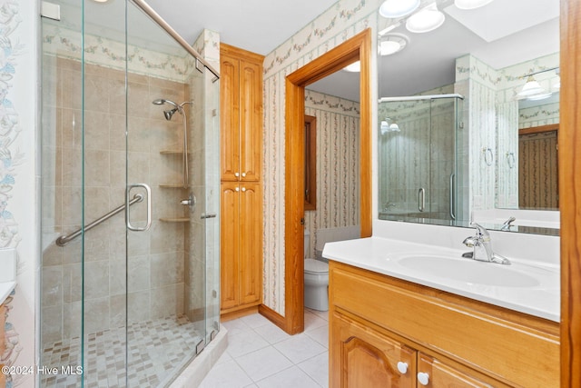 bathroom with vanity, a shower with door, a skylight, tile patterned flooring, and toilet