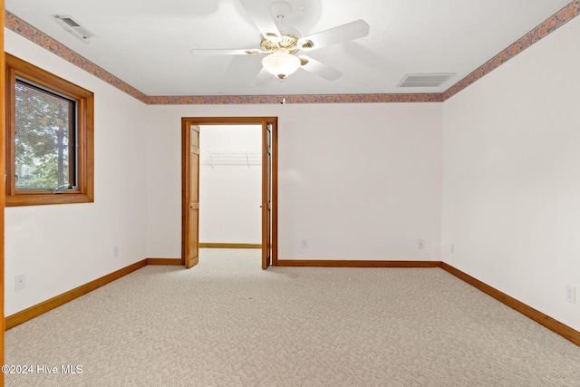 carpeted empty room with ceiling fan