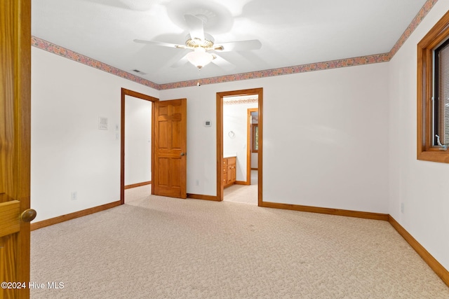 carpeted empty room featuring ceiling fan