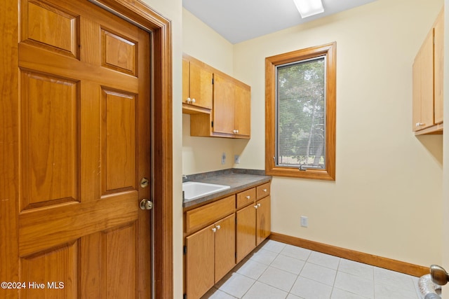 kitchen featuring light tile patterned flooring and sink