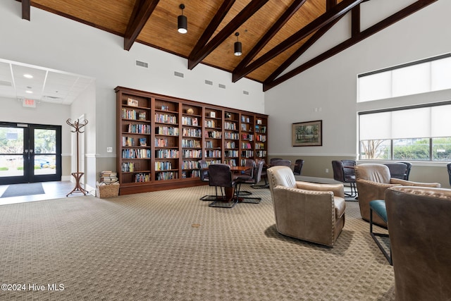 interior space featuring carpet flooring, high vaulted ceiling, wood ceiling, and beam ceiling