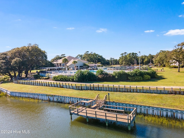 dock area with a lawn and a water view