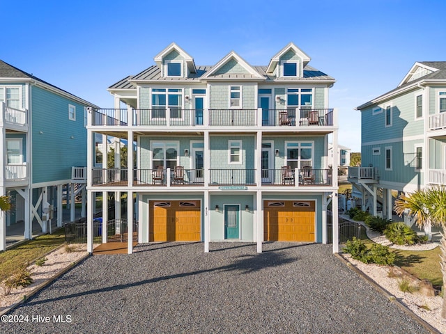 view of front of home with a garage and a balcony