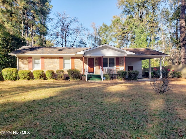 ranch-style home featuring a front yard, a porch, and a carport