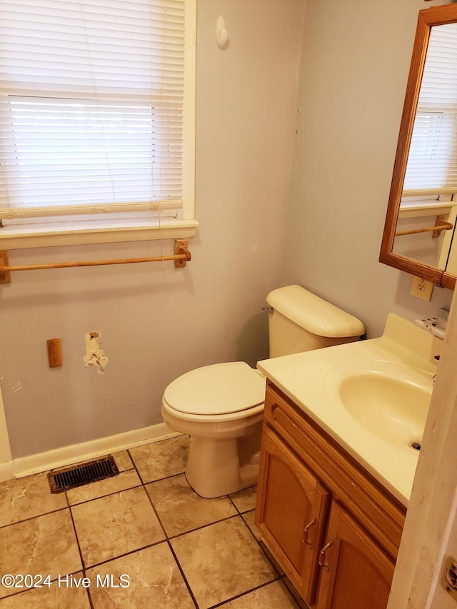 bathroom featuring tile patterned floors, vanity, and toilet