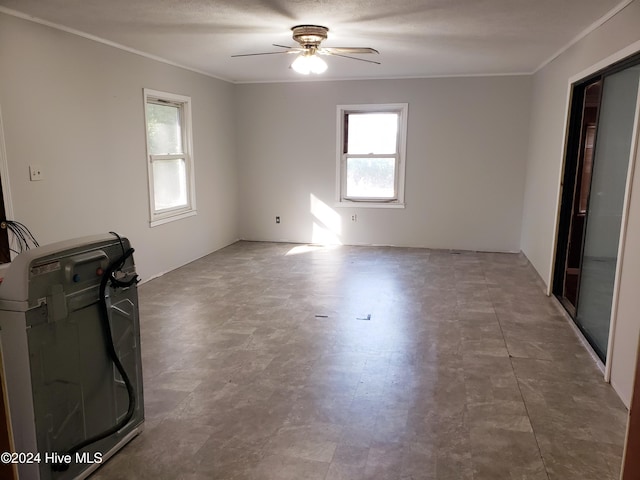 empty room with a textured ceiling and ceiling fan