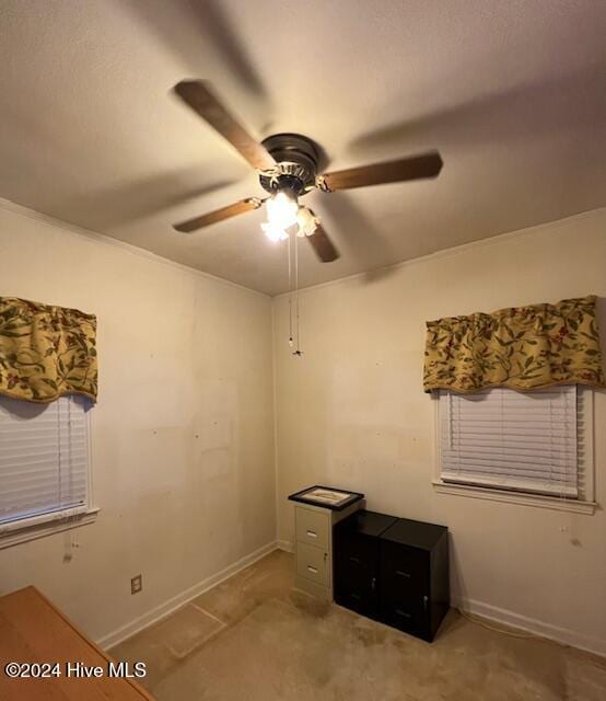 interior space with ceiling fan