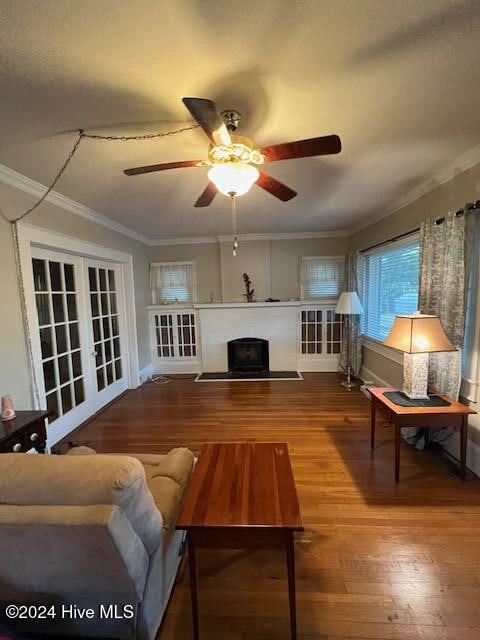 living room with ceiling fan, hardwood / wood-style floors, and crown molding