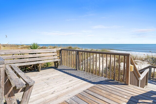 deck with a water view and a beach view