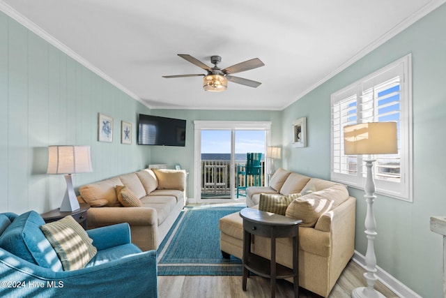 living room featuring ornamental molding, ceiling fan, and light hardwood / wood-style flooring