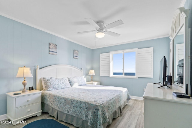 bedroom featuring ornamental molding, ceiling fan, and light hardwood / wood-style flooring